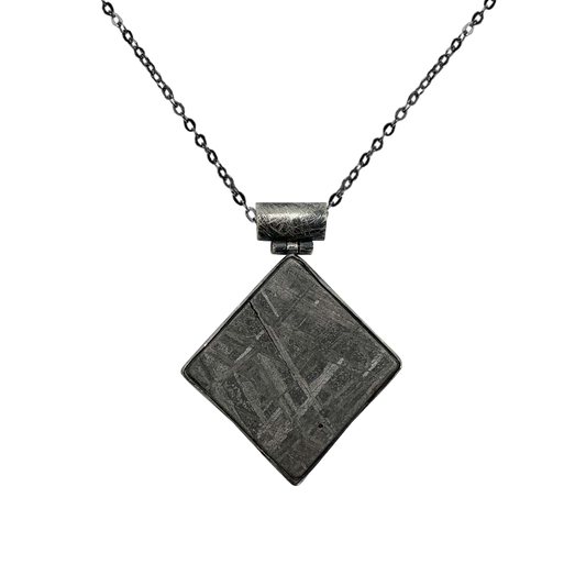 Irregular-shaped meteorite pendant with beveled chain cylinder