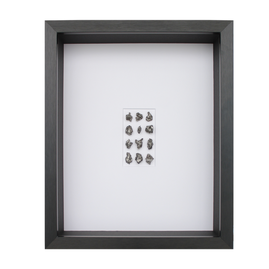 Frame with 70-80 grams of meteorite, black aluminum frame.
